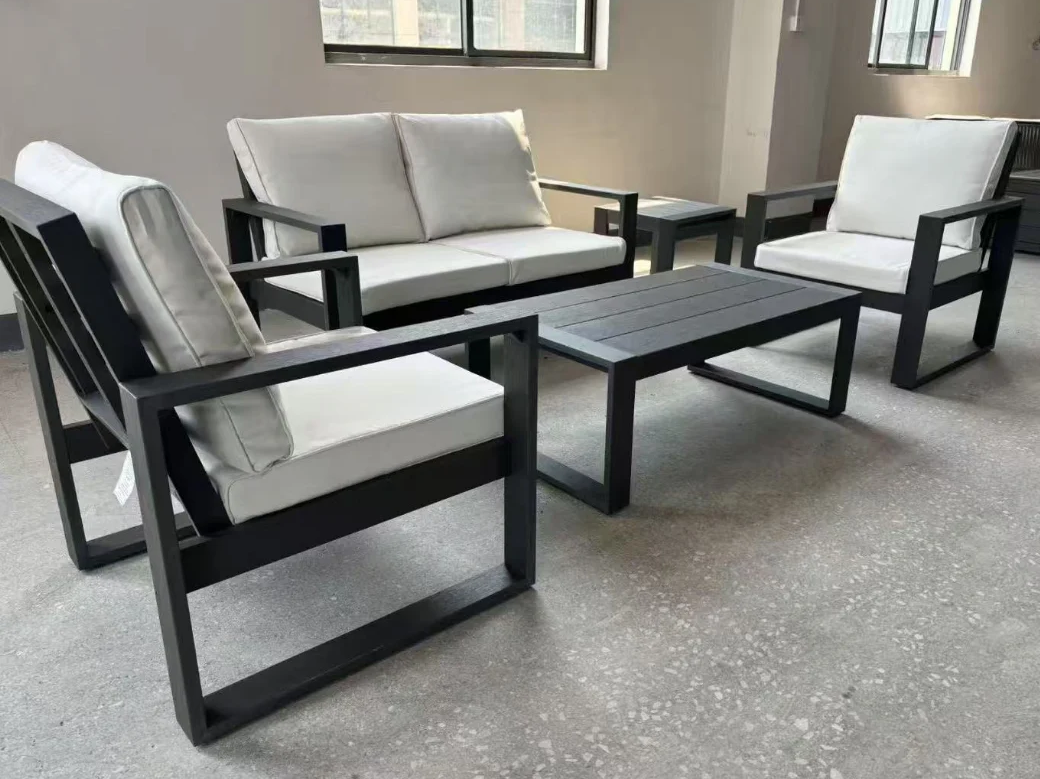 A Sleek outdoor furniture set with black frames and white cushions