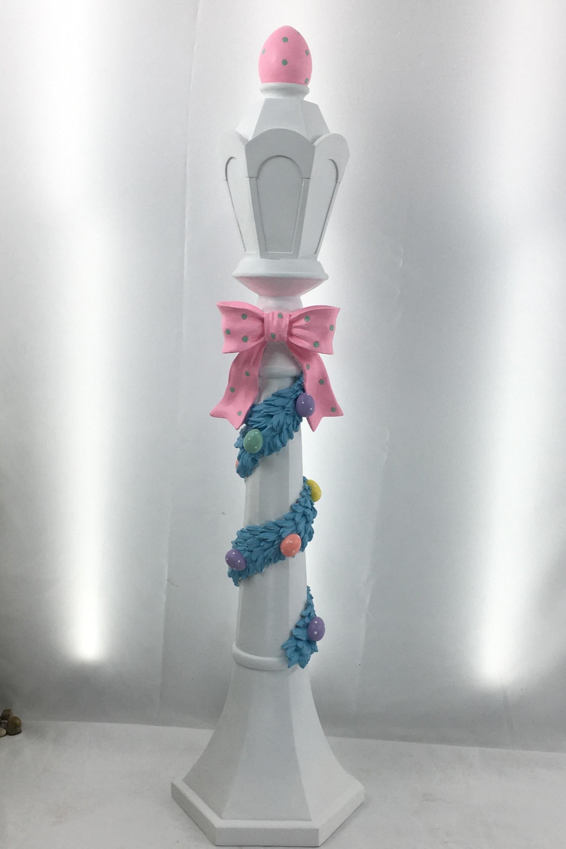 Decorative stand with a pink top and colorful base, perfect as an indoor or outdoor decoration for a pond